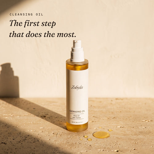 Zobyda Cleansing Oil 140ml bottle on travertine in warm afternoon sunlight