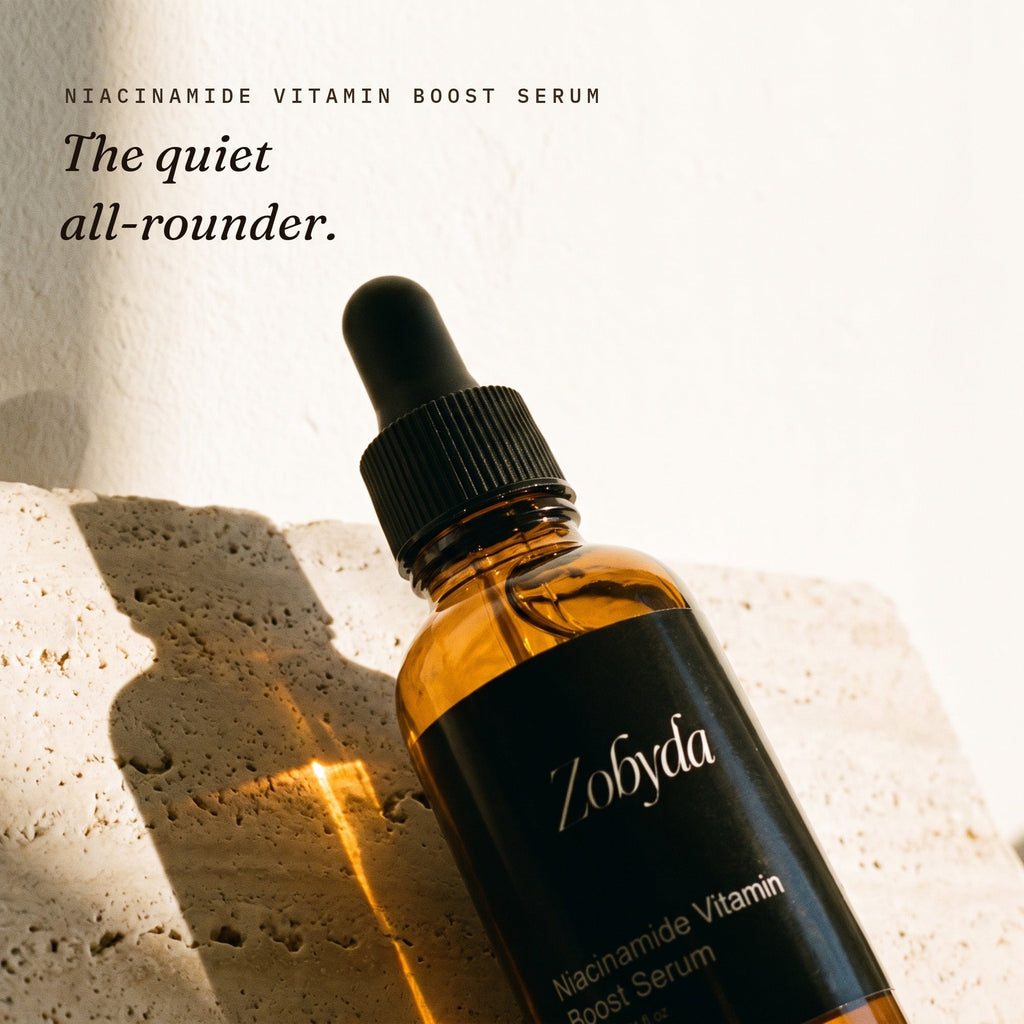 Zobyda Niacinamide Vitamin Boost Serum 30ml bottle on travertine in morning sunlight