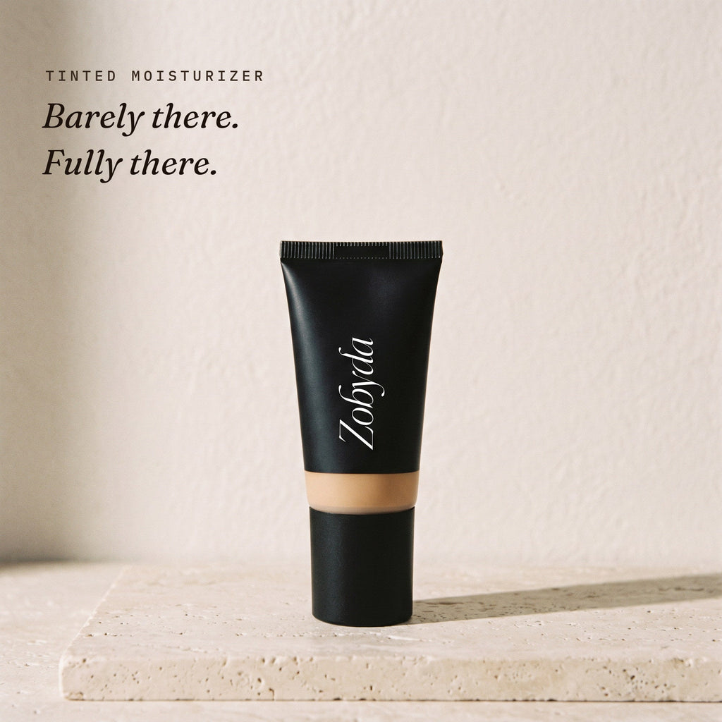 Zobyda Tinted Moisturizer 30ml tube on travertine in clear morning light