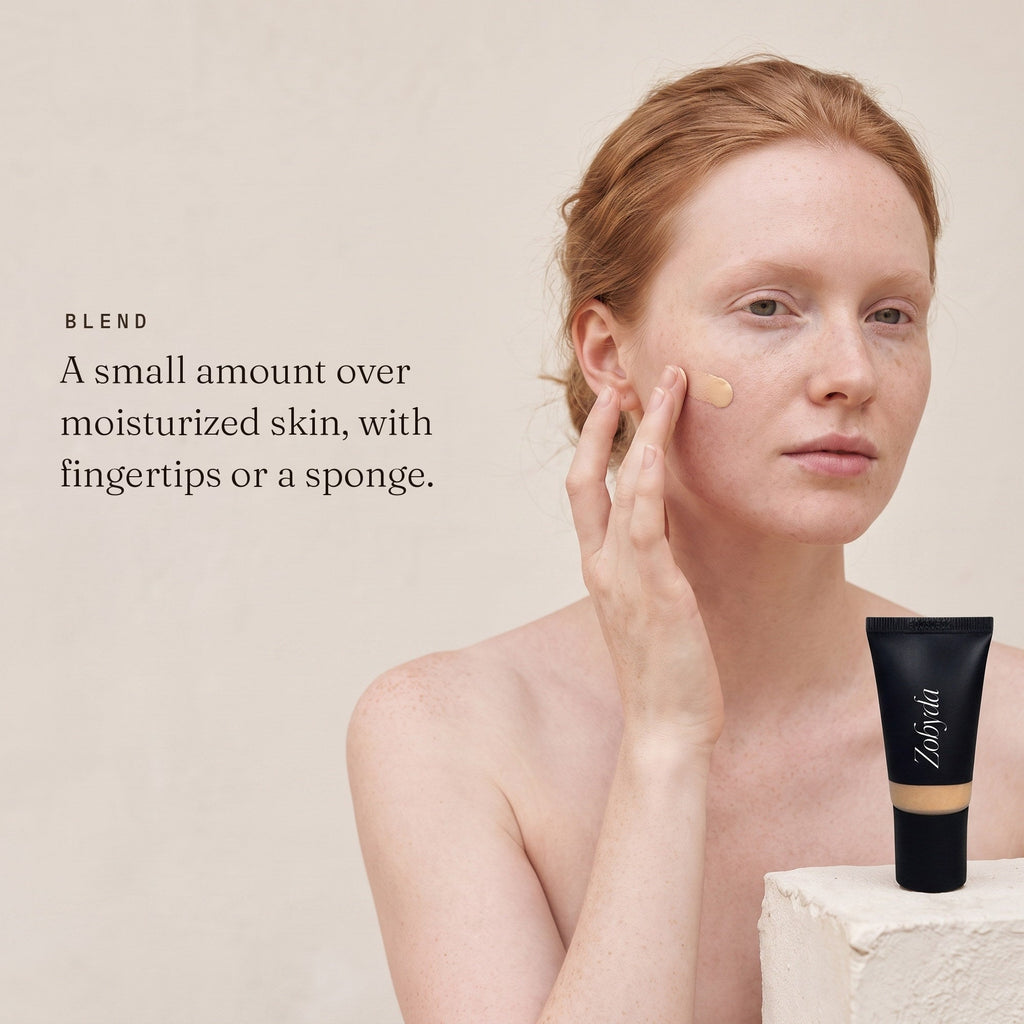 Blending Zobyda Tinted Moisturizer with fingertips over moisturized skin
