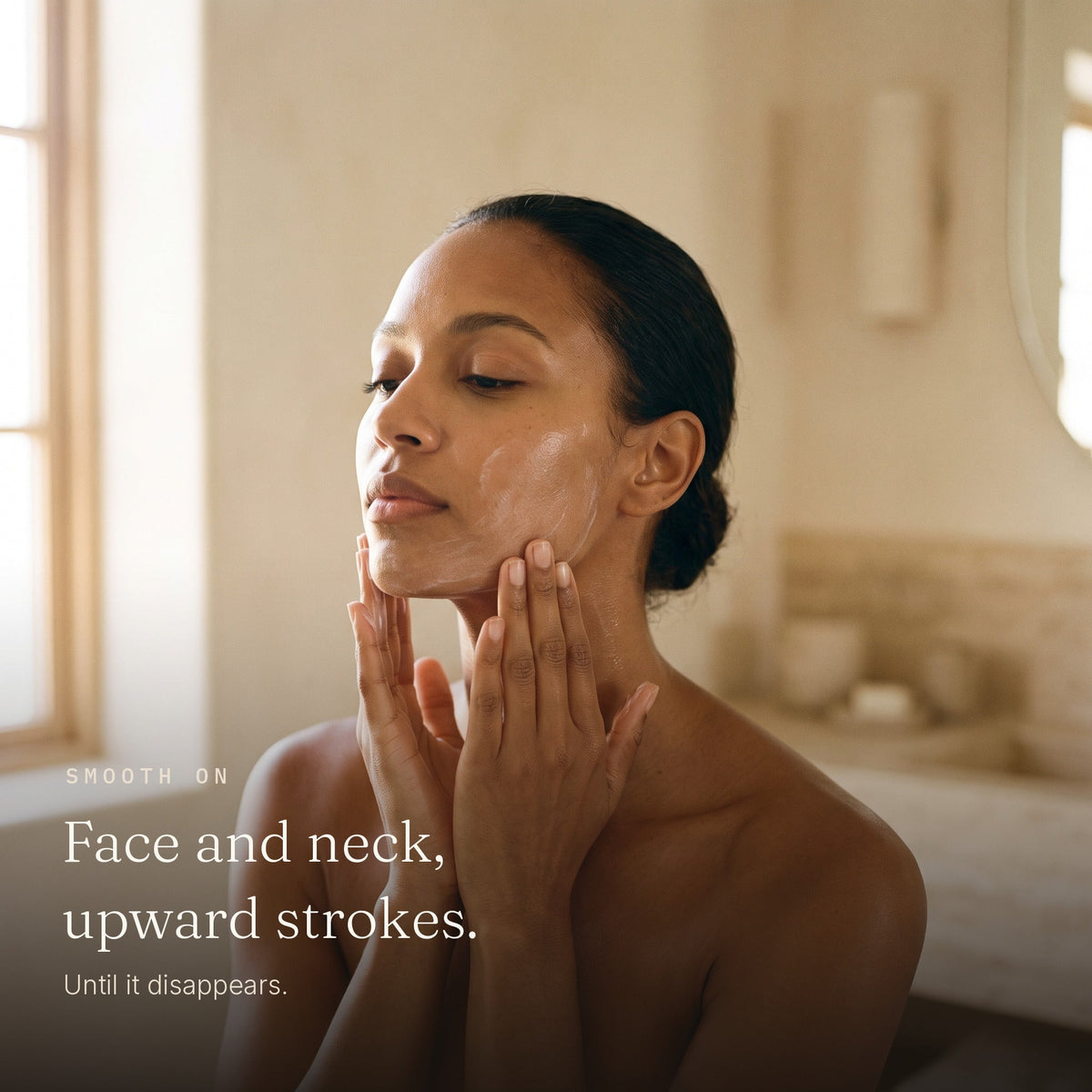 Woman smoothing Zobyda Oil-Free Daily Moisturizer over her face and neck in upward strokes
