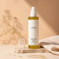 Zobyda Cleansing Oil bottle in warm cream skincare scene